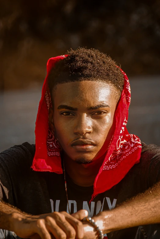 a boy wearing a hoodie stares intently at the camera