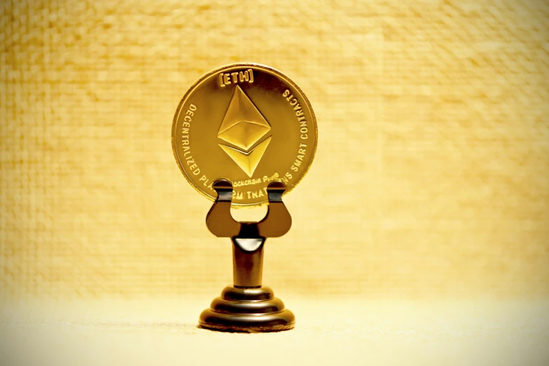 a gold coin sitting on top of a wooden stand