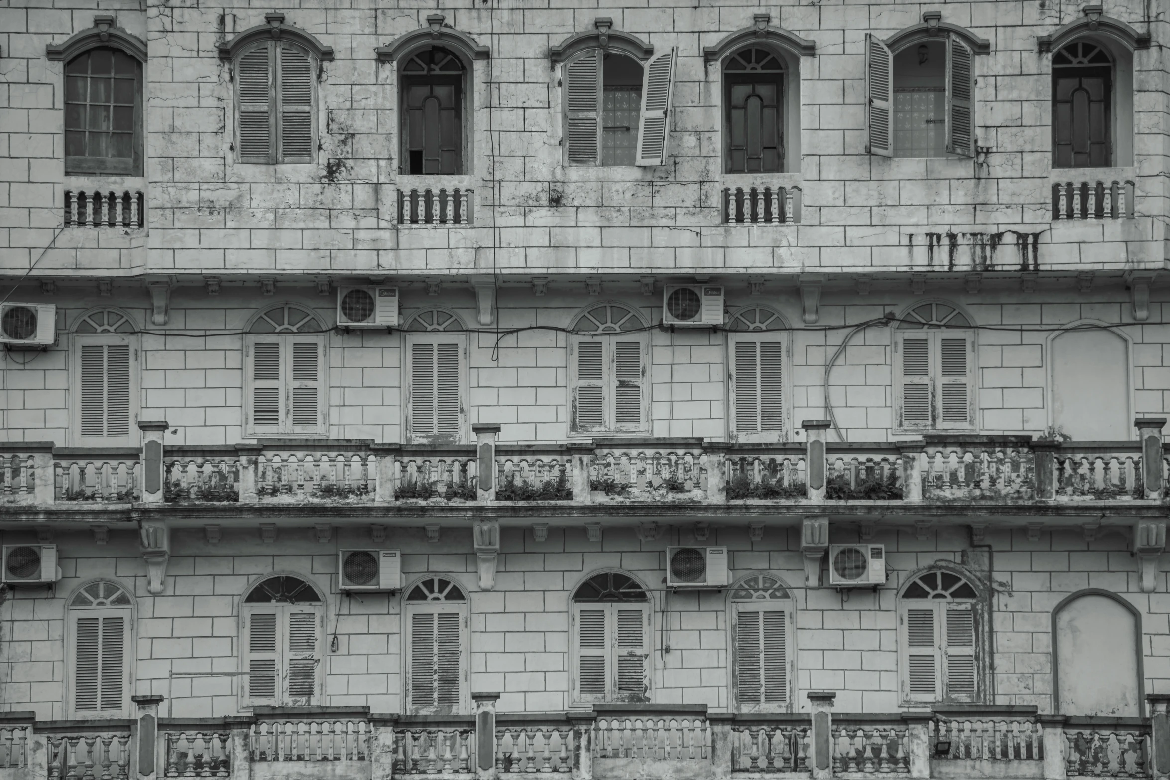 an old white building with balconies and windows