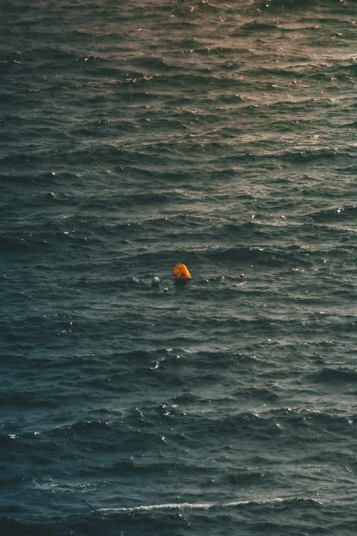 there is a floating orange object in the ocean