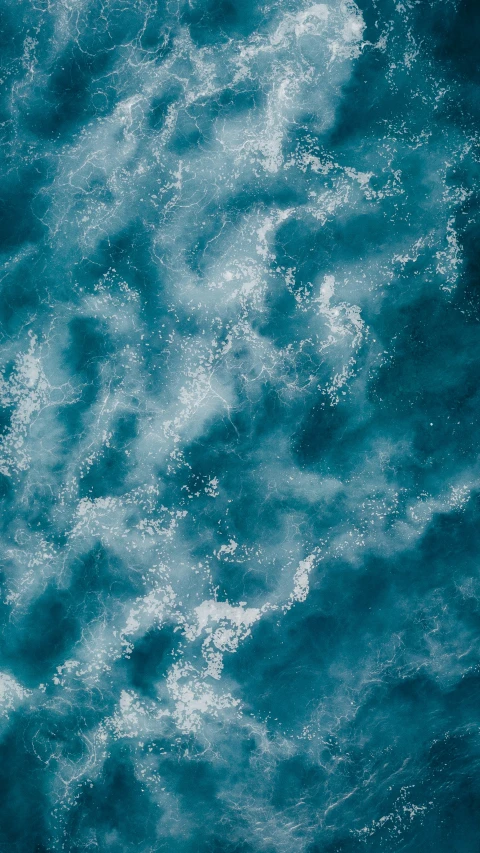 a boat floating in the water near waves