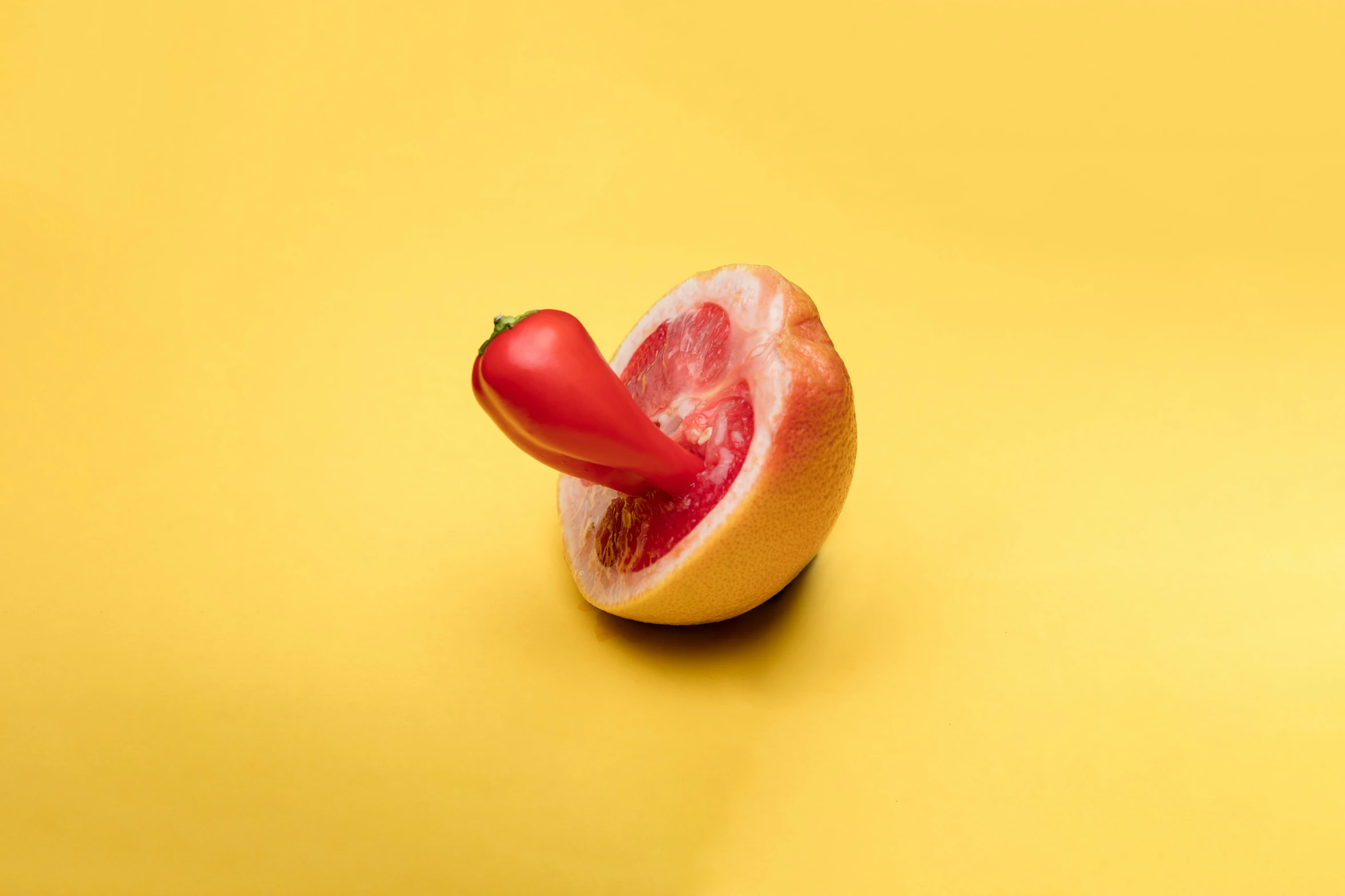 one small piece of fruit with tomato and lime attached