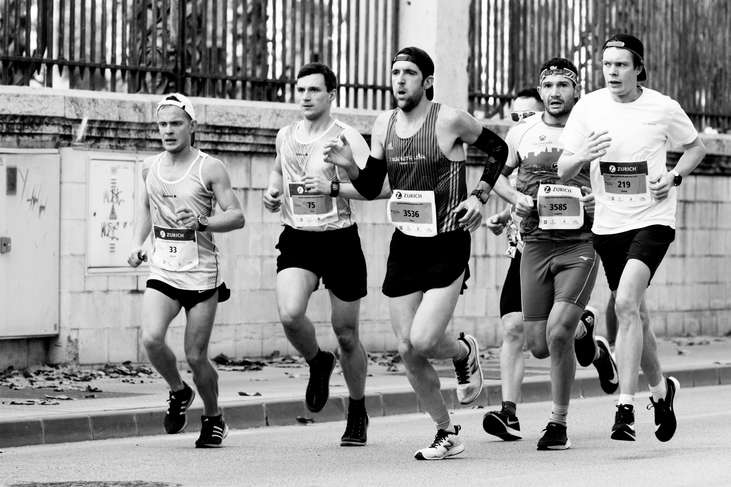 a group of runners racing down the street