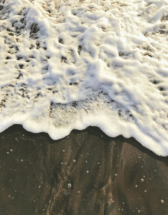 small waves rolling onto a sandy beach