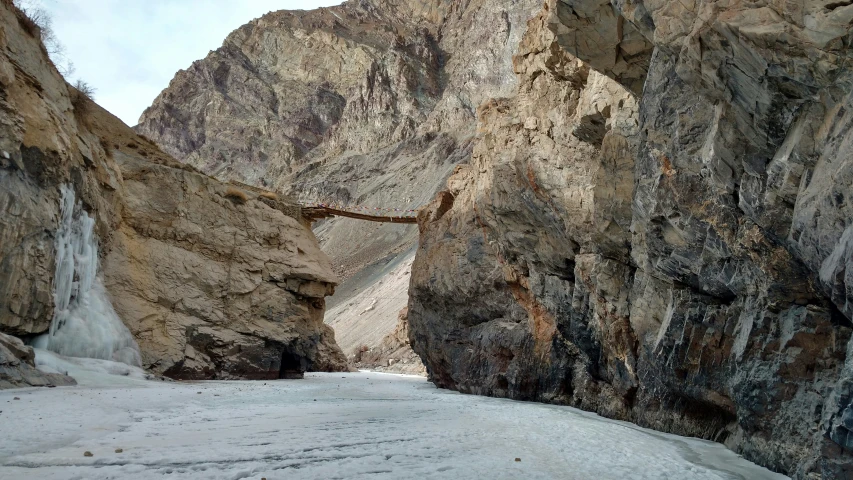 a narrow stream between two mountains that are not very steep