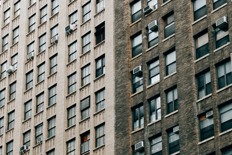 tall brown brick buildings with broken windows in them