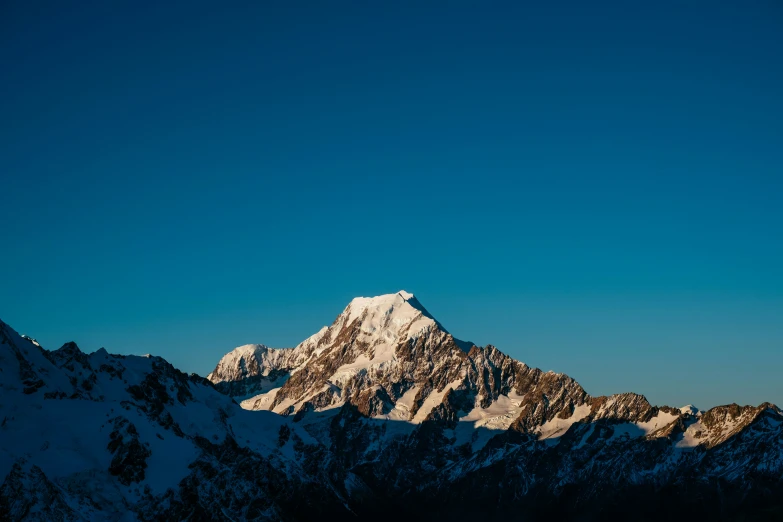 a view of the top of a large snowy mountain