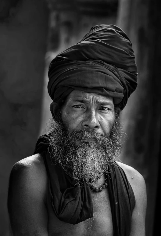 a black and white po of a man wearing a turban
