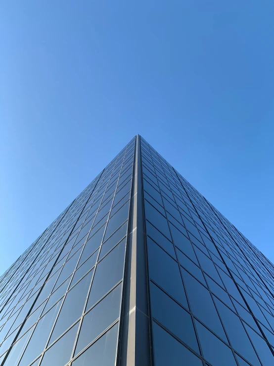 an upward view of a building and a street sign