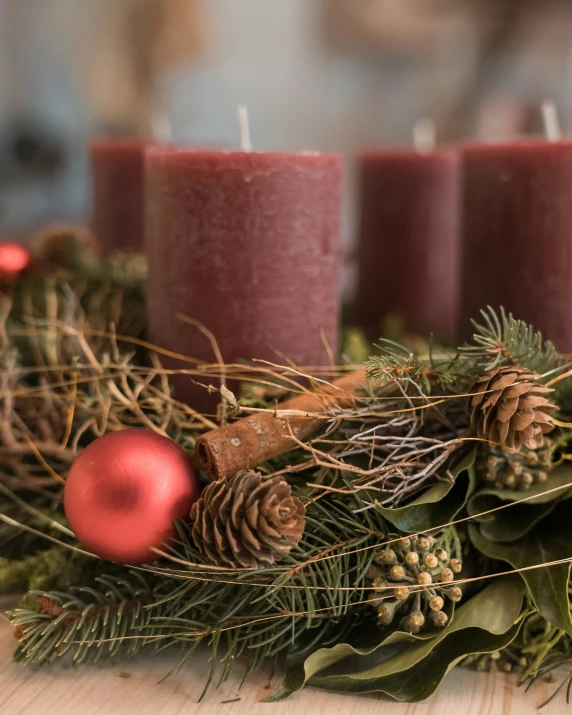 a christmas wreath with pine cones and evergreen cones