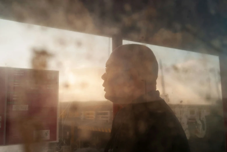 a man looking out the window in front of him