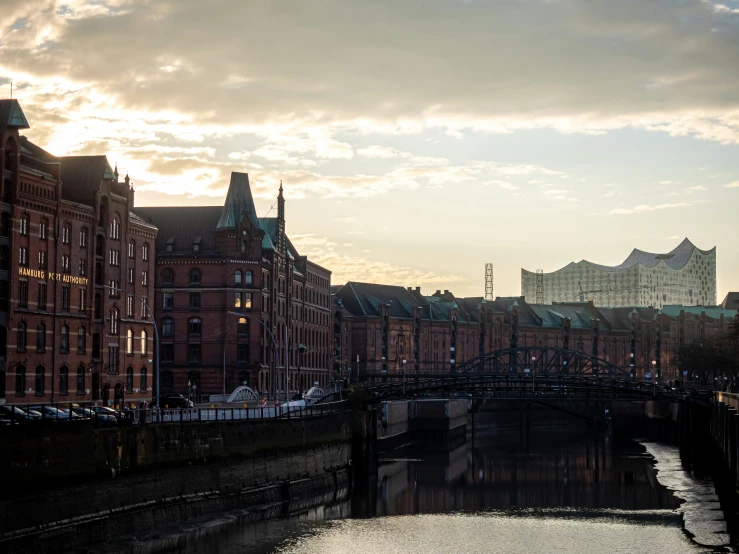 the skyline is seen across the canal from a large brick building