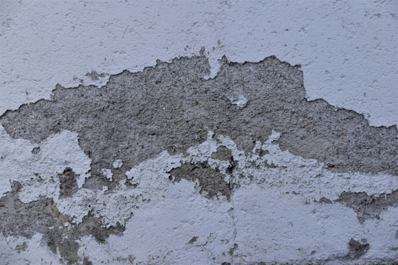 an old stucco wall with rust and s