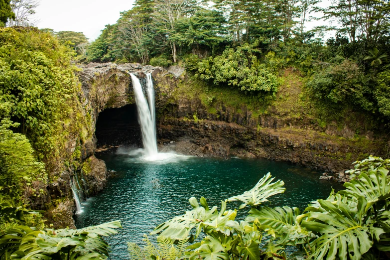 a waterfall in the middle of some water