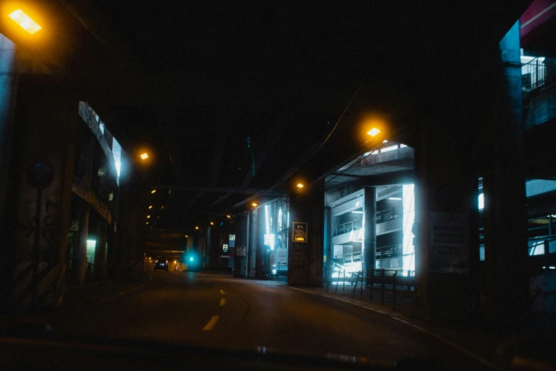 a street at night with the headlights on