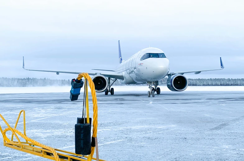 a person standing by a ladder next to an airplane