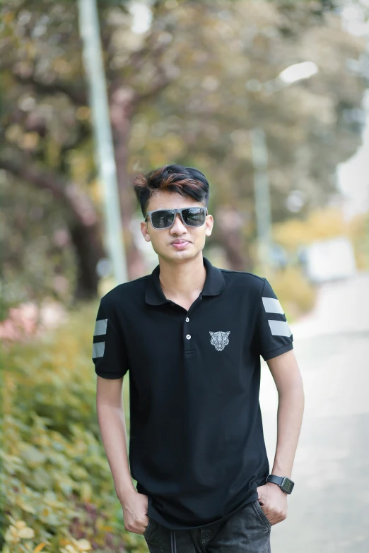 a young man in a black shirt posing for a po