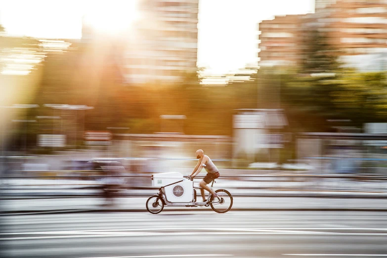 a woman riding on a bike down the street