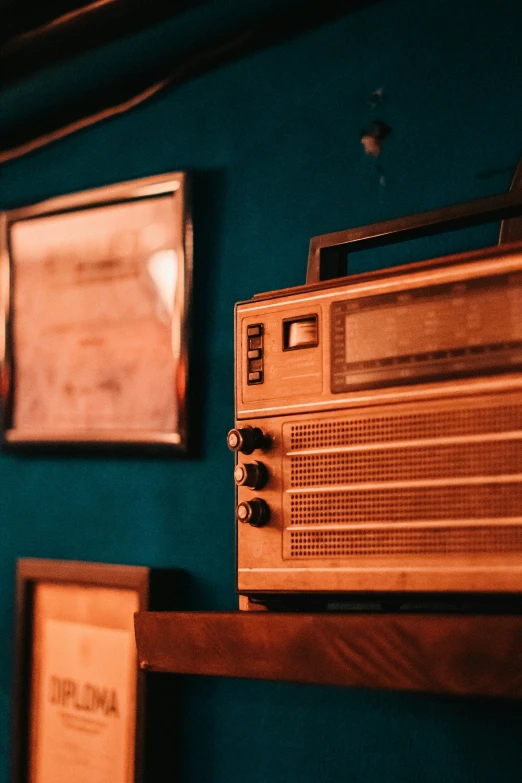 a wall with pictures and radio on it