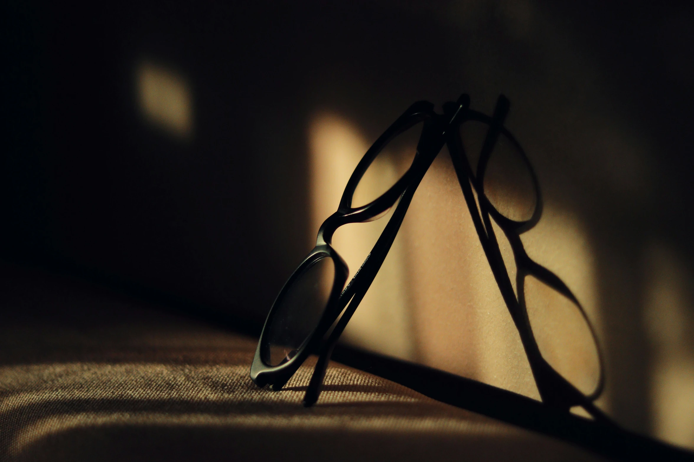 an eyewear and a shadow in a room