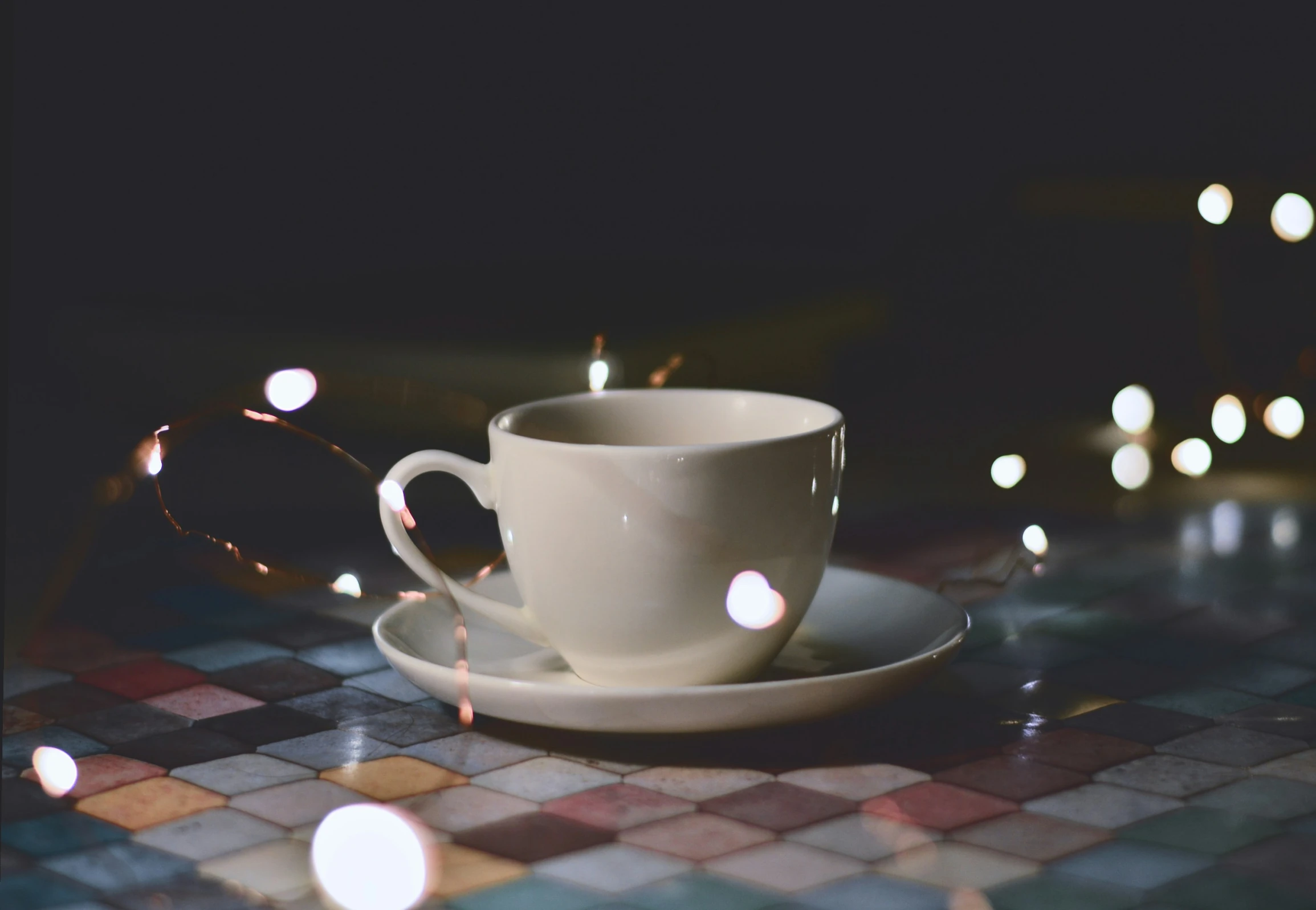 a cup of coffee sits on the tile