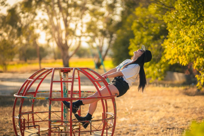 an image of a young woman climbing the ladder on the top of a small toy house