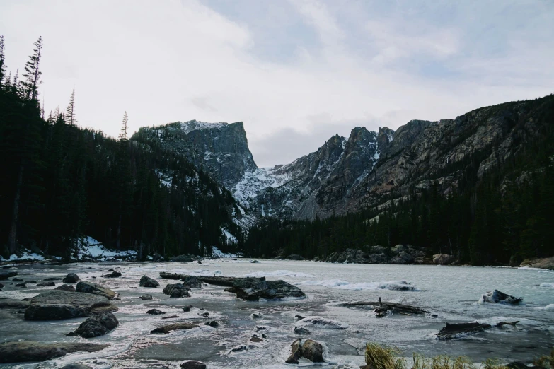 a rocky river in a snowy mountain wilderness