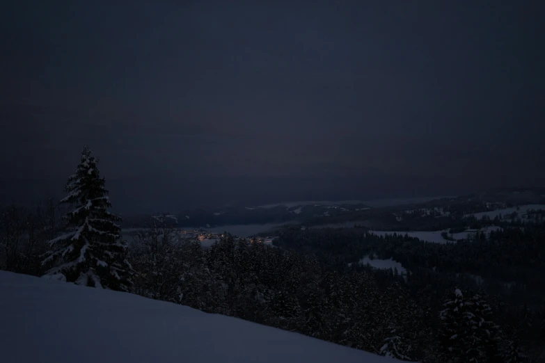 a person is seen from top of a snowy hill