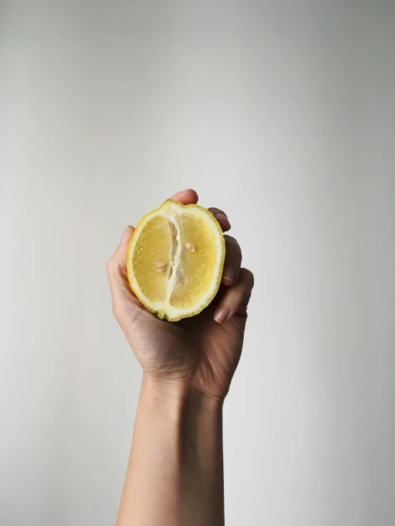 someone is holding a half - eaten lemon to the camera