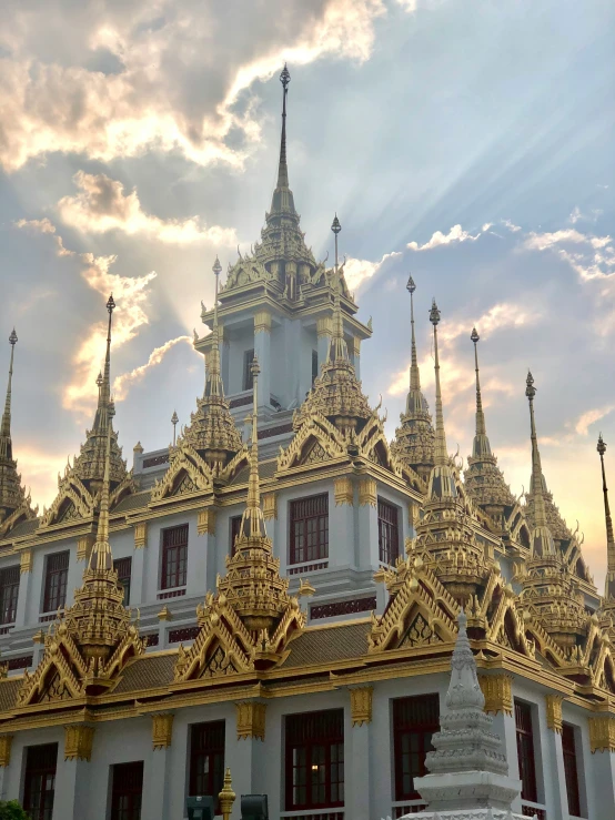 an ornate building with white gold detailing on the top