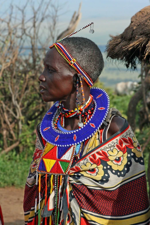 an african woman wearing a beaded necklace and statement necklace