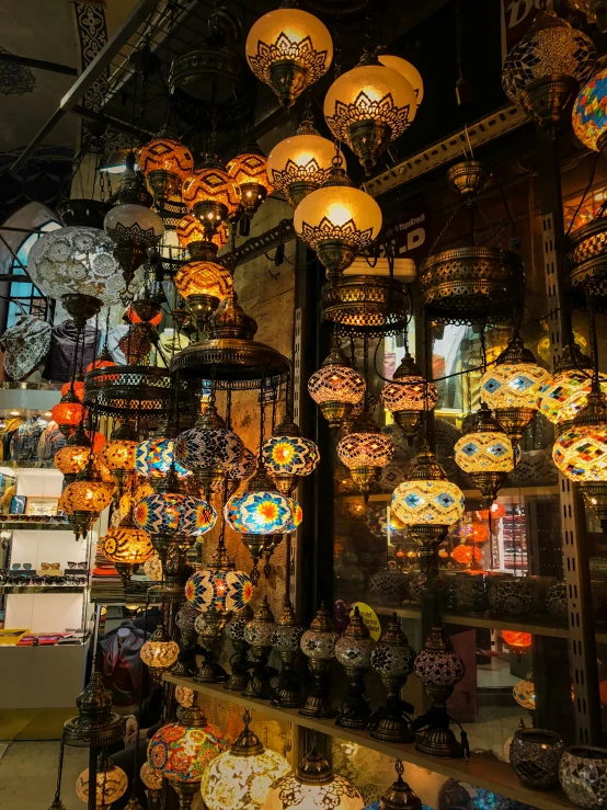 many colored lights hanging from the ceiling of a store