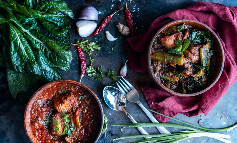 a close up of two bowls of food on a table