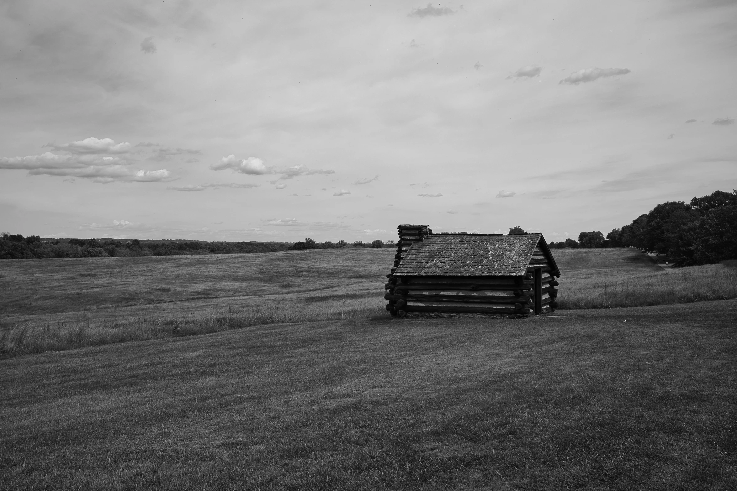 a farm house that is out in the grass