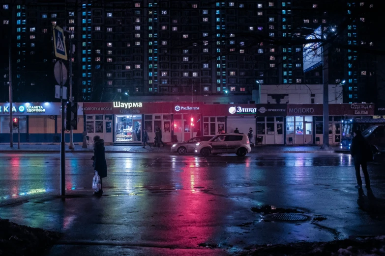 two people are crossing the street in front of a building