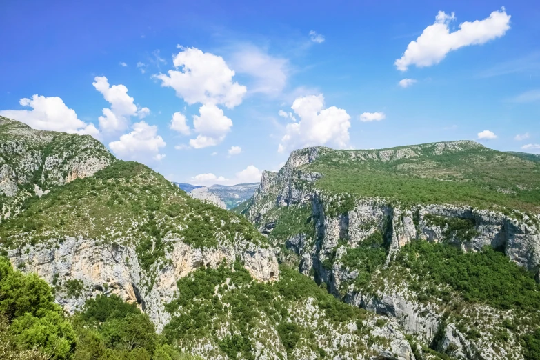 a mountain covered with lots of rocks and lush green trees