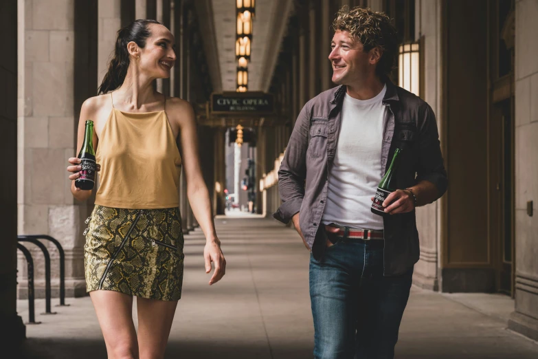 the man and woman are walking on the sidewalk