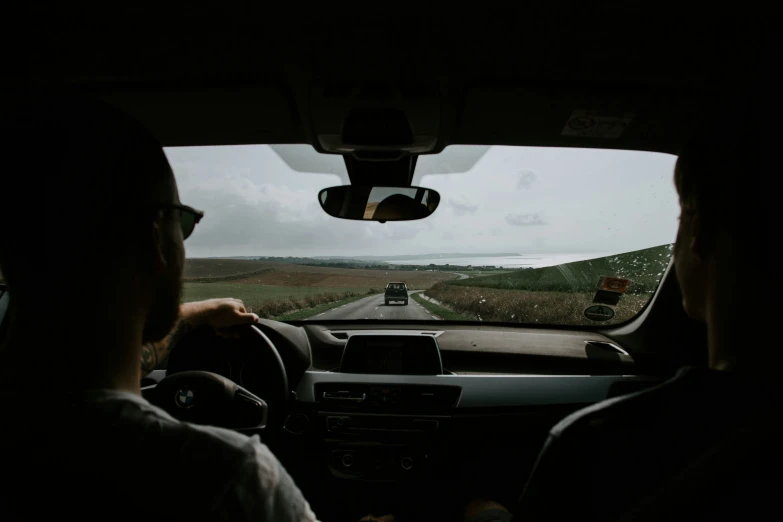 a couple of people riding in the passenger seat of a car