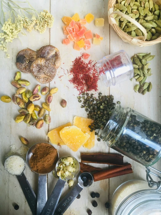 a variety of spices next to some utensils