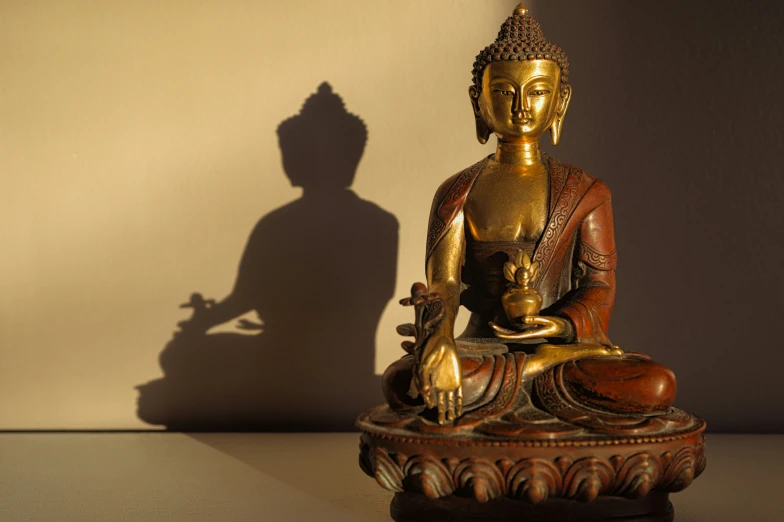 a golden buddha statue sitting in the middle of the room