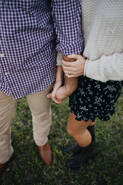 two people holding hands close to each other