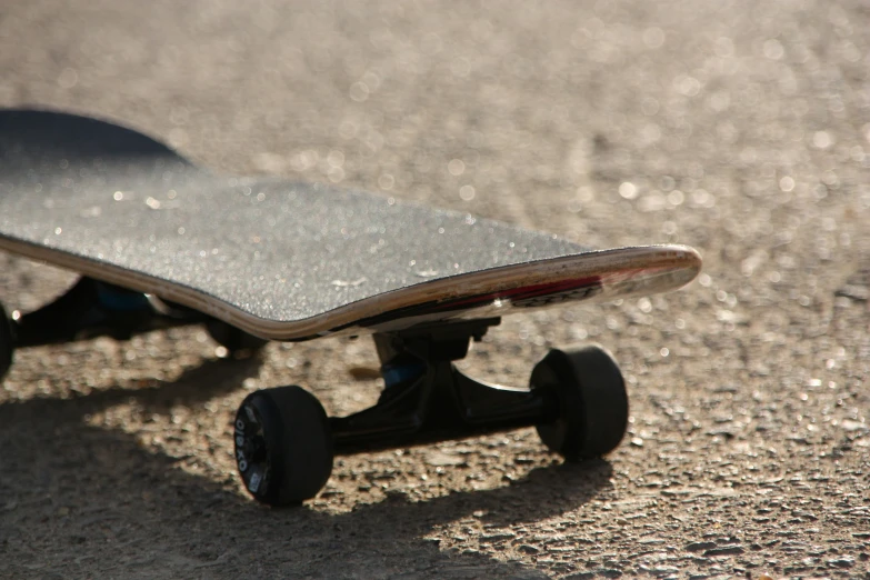 a skateboard with wheels that is laying on the ground