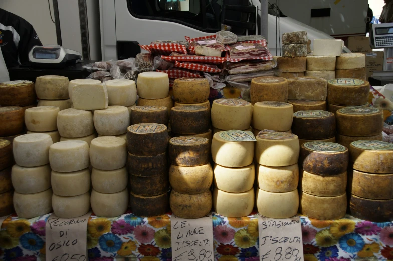 different types of cheese are displayed for sale