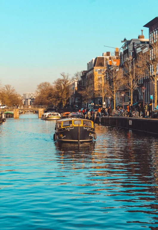 small boats with passengers on the river in the city