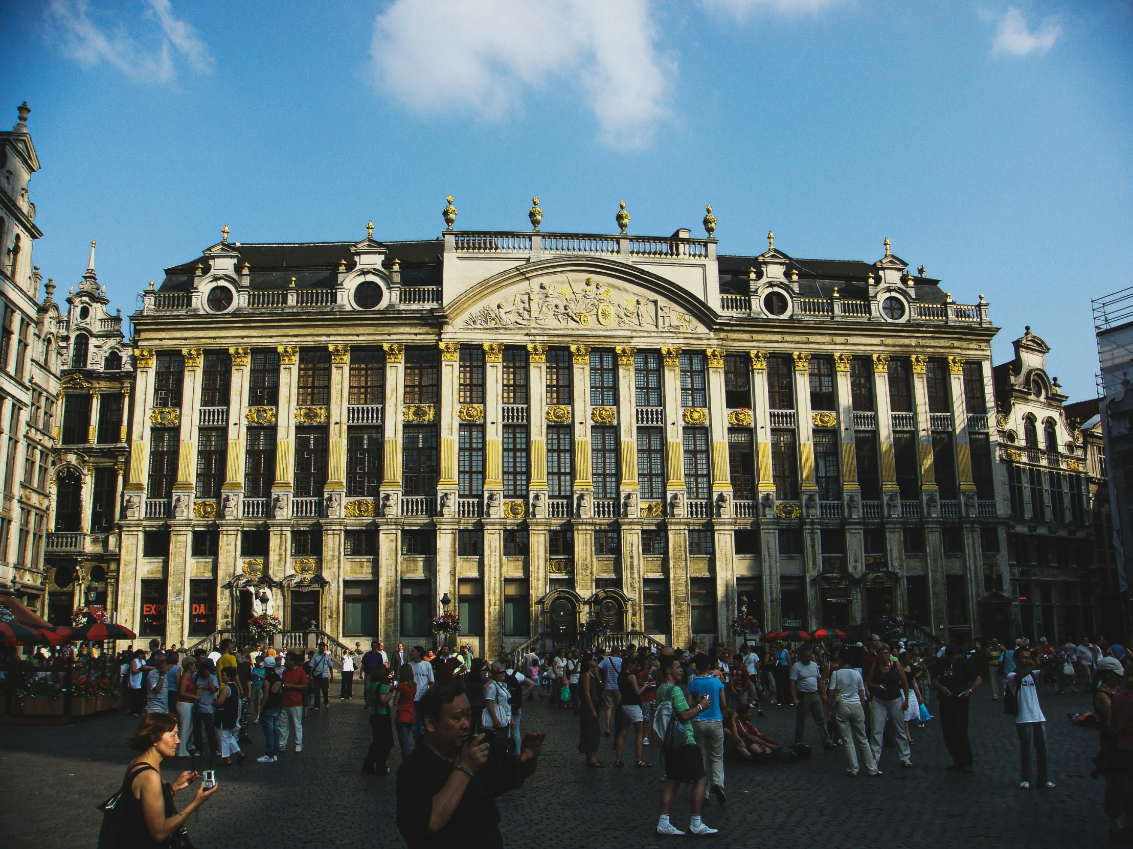 people standing outside an old building in the city