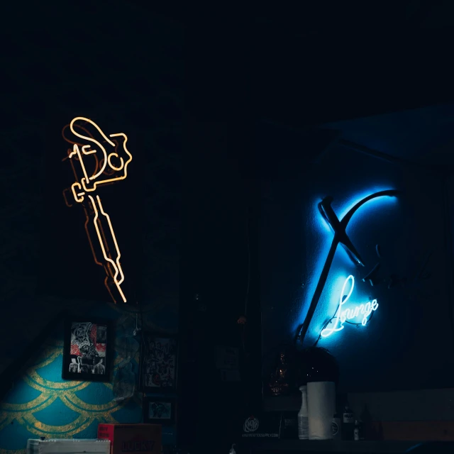 a neon sign in a dark room next to a neon neon light
