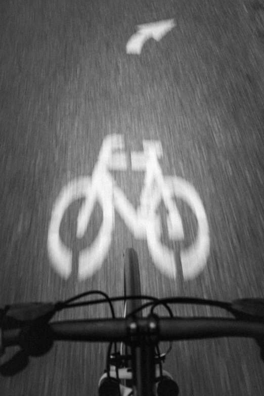 a bike trail has white painted bikes on the ground