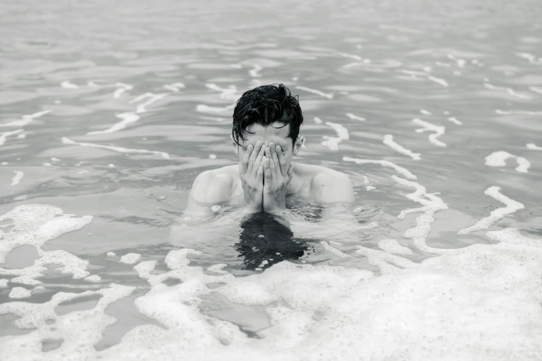 a person in water with their face in the air