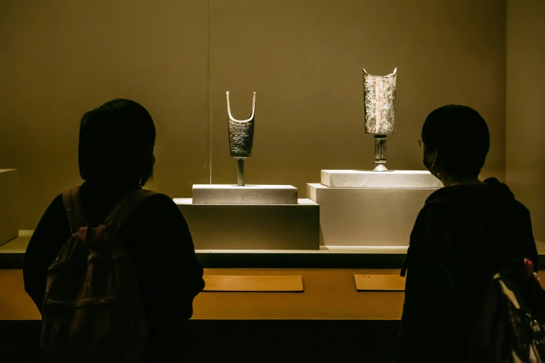 two girls look at a display in a museum