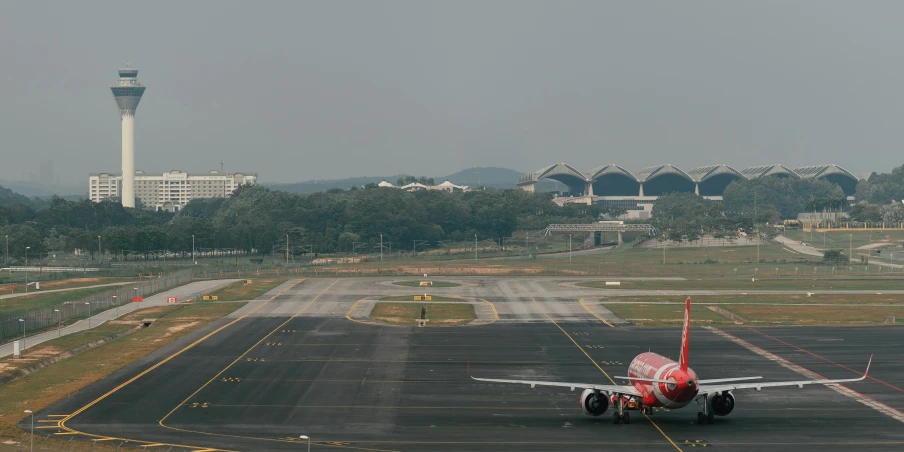 a large plane is on an empty runway